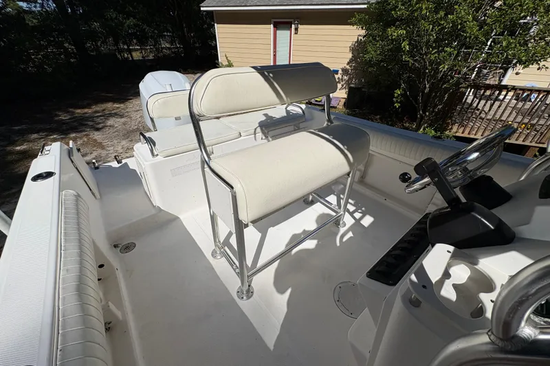Slide: The Image of 2005 Century 2200 Center Console boat interior with steering wheel and seating. - 19