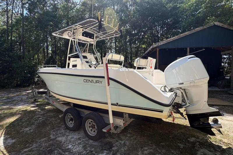 Slide: The Image of 2005 Century 2200 Center Console boat on trailer, parked outdoors. - 2