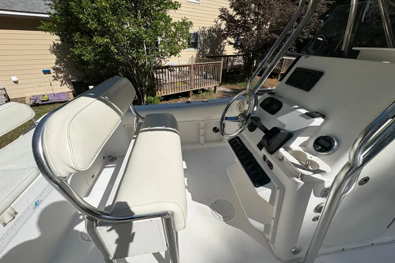 Slide: The Image of 2005 Century 2200 Center Console boat interior with steering wheel and seating. - 21
