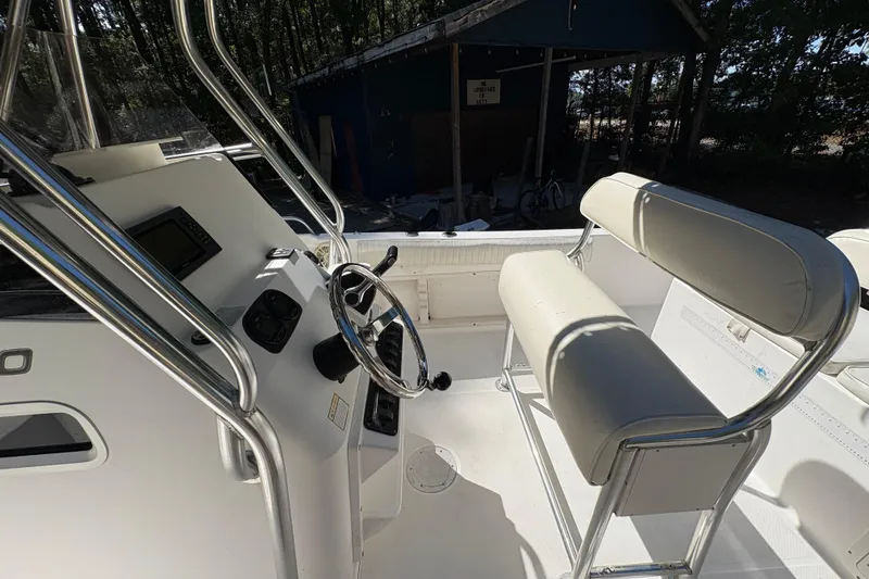 Slide: The Image of 2005 Century 2200 Center Console boat interior with steering wheel and seating. - 22