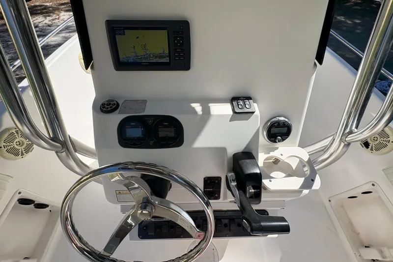 Slide: The Image of Century 2200 Center Console 2005 boat dashboard with steering wheel and navigation equipment. - 25
