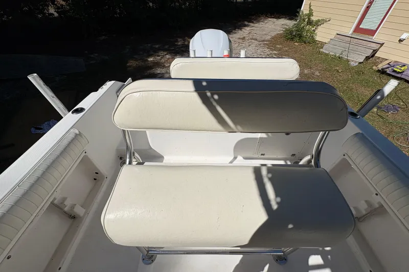 Slide: The Image of 2005 Century 2200 Center Console boat interior with white seating and console view. - 26