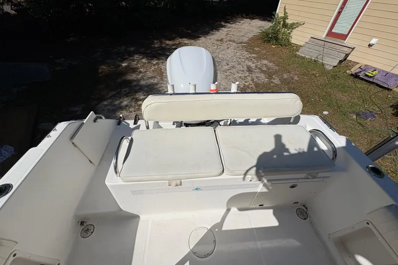 Slide: The Image of 2005 Century 2200 Center Console boat interior with seating and engine view. - 27