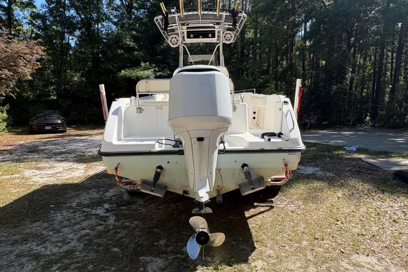 Slide: The Image of 2005 Century 2200 Center Console boat with outboard motor in a wooded area. - 3