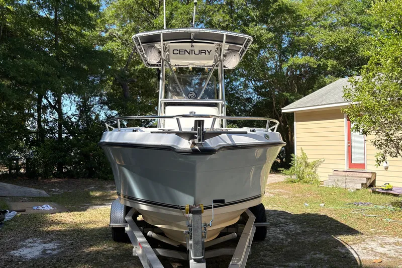 Slide: The Image of 2005 Century 2200 Center Console boat on trailer, surrounded by trees and a yellow building. - 7