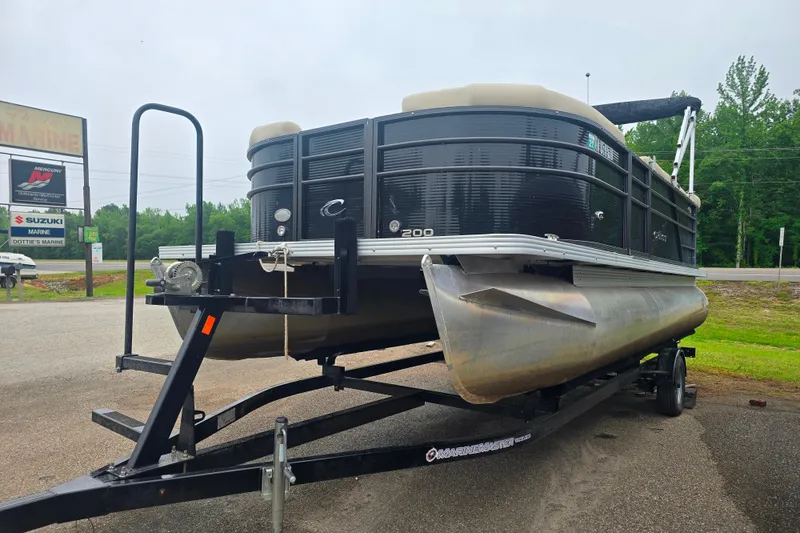 The Image of 2019 Crest I L Cp2 pontoon boat on trailer at marine dealership. - 1