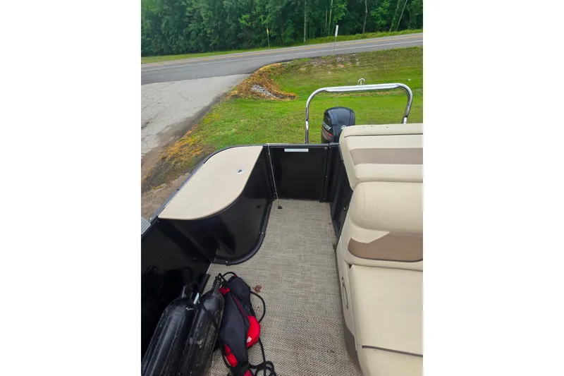 Slide: The Image of 2019 Crest I L Cp2 boat interior with beige seating and Mercury outboard motor. - 10
