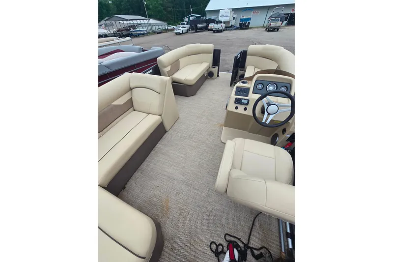 Slide: The Image of Interior of 2019 Crest I L Cp2 pontoon boat with beige seating and steering console. - 12