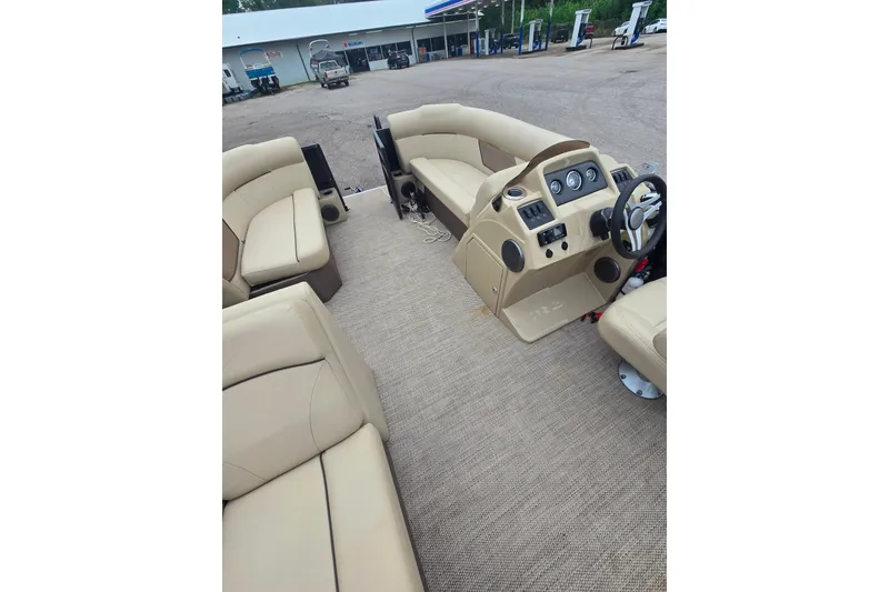 Slide: The Image of 2019 Crest I L Cp2 pontoon boat interior with beige seating and control panel. - 13
