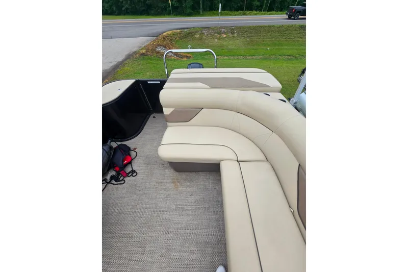 Slide: The Image of 2019 Crest I L Cp2 boat interior with beige seating and outdoor view. - 14