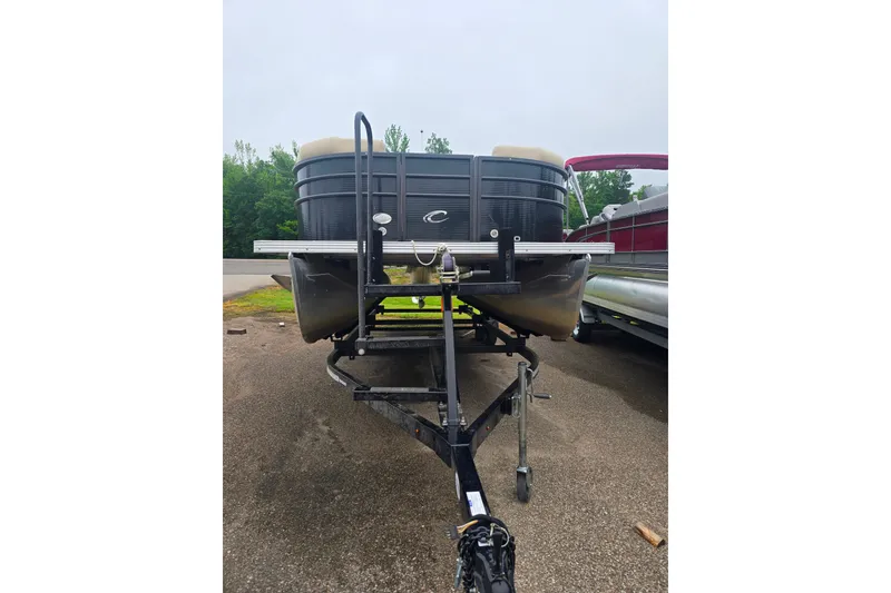 Slide: The Image of 2019 Crest I L Cp2 pontoon boat on trailer, parked outdoors. - 2