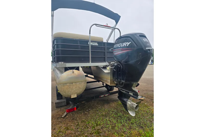 Slide: The Image of 2019 Crest I L Cp2 pontoon boat with Mercury outboard motor on a trailer. - 7