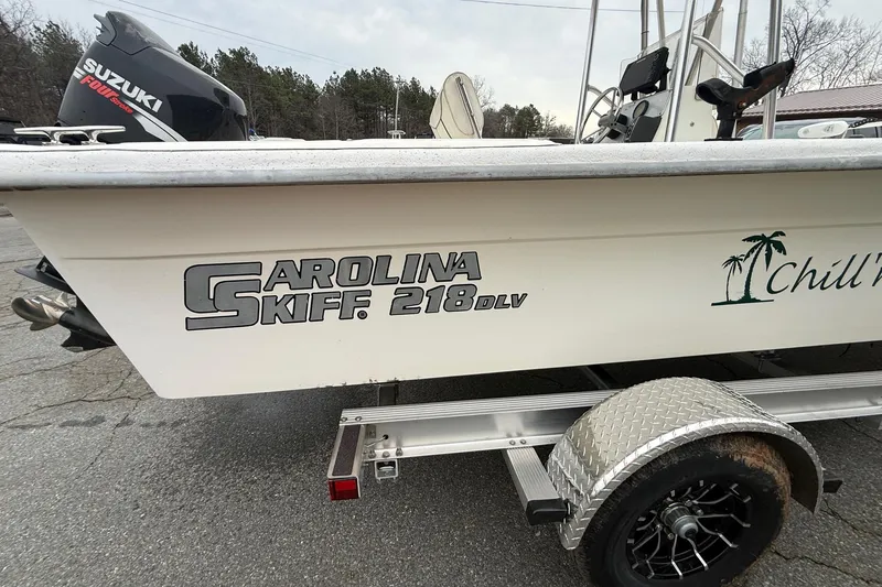 Slide: The Image of 2008 Carolina Skiff 218 DLV boat on trailer with Suzuki engine, side view. - 10