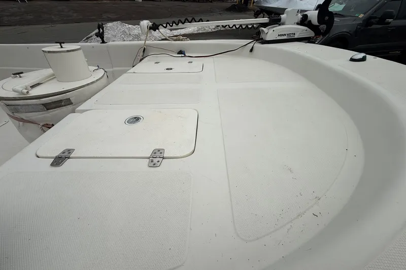 Slide: The Image of 2008 Carolina Skiff 218 DLV boat deck with storage compartments and Minn Kota trolling motor. - 12