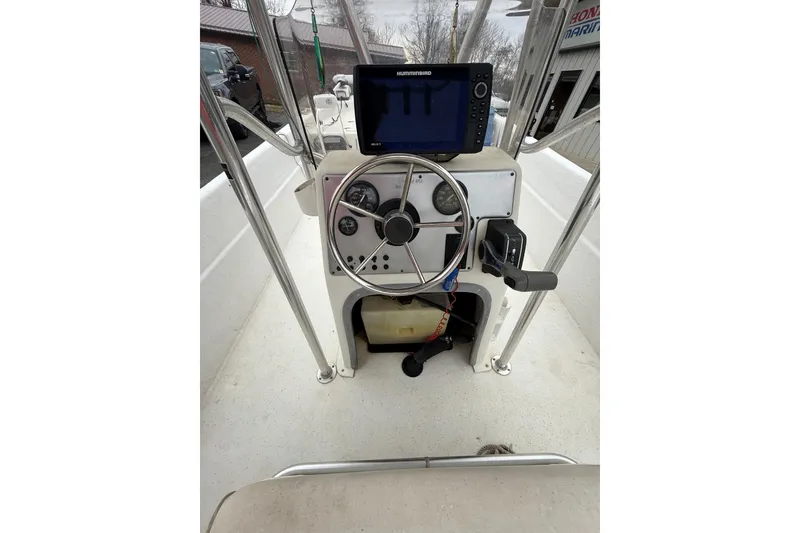 Slide: The Image of Center console of a 2008 Carolina Skiff 218 DLV with steering wheel and navigation equipment. - 14