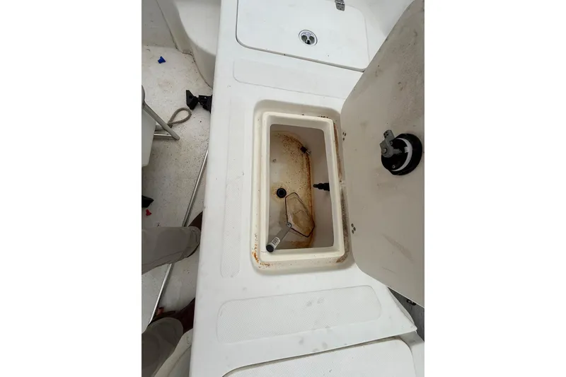 Slide: The Image of Open storage compartment on a 2008 Carolina Skiff 218 DLV boat deck. - 15