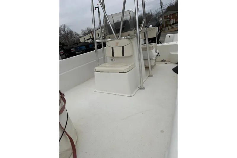 Slide: The Image of 2008 Carolina Skiff 218 DLV boat interior with seating and console, overcast day. - 4