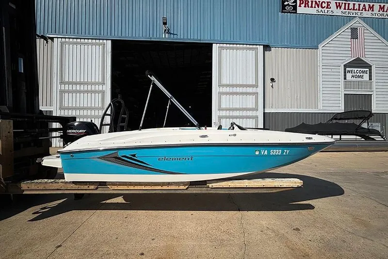 The Image of 2022 Bayliner Element E18 boat in front of a marina building. - 0