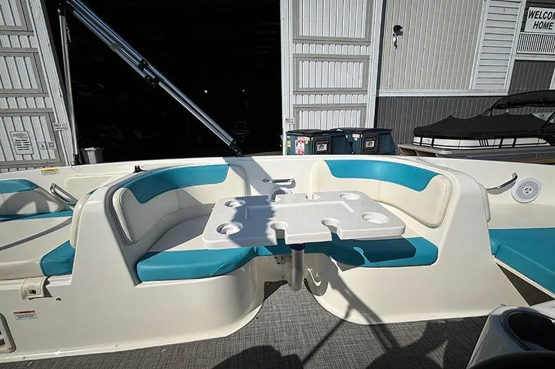 Slide: The Image of 2022 Bayliner Element E18 boat interior with blue seating and a central table. - 14