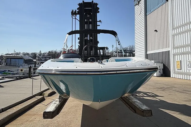 Slide: The Image of 2022 Bayliner Element E18 boat on dock, blue hull, sunny day. - 2