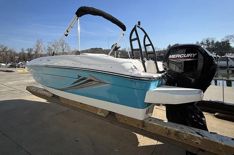 Slide: The Image of 2022 Bayliner Element E18 boat with Mercury engine on a dock under clear skies. - 4