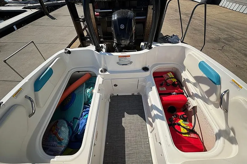 Slide: The Image of 2022 Bayliner Element E18 boat interior with storage compartments and outboard motor. - 8