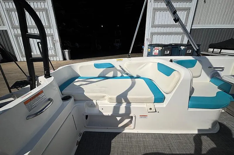 Slide: The Image of 2022 Bayliner Element E18 boat interior with white and blue seating. - 9