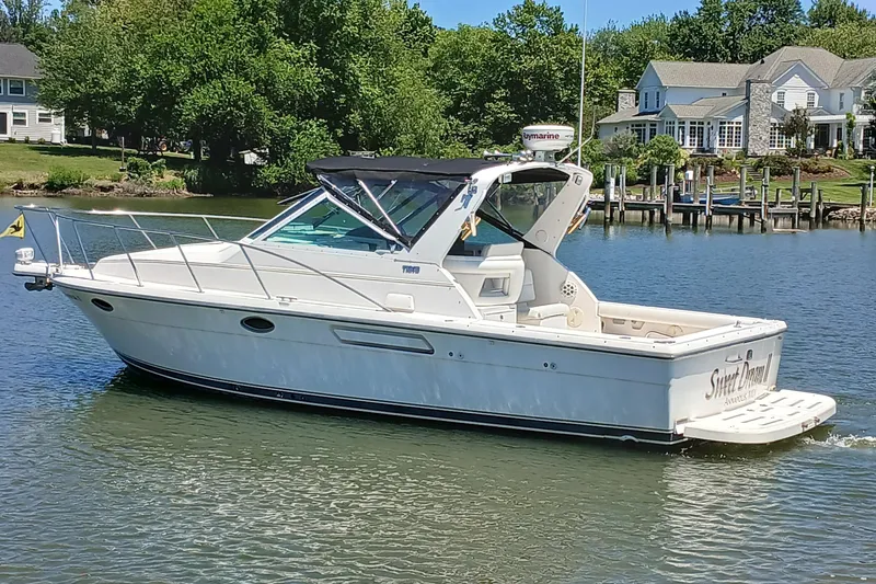The Image of 2001 Tiara Yachts 2900 Open cruising on a serene lake near waterfront homes. - 0