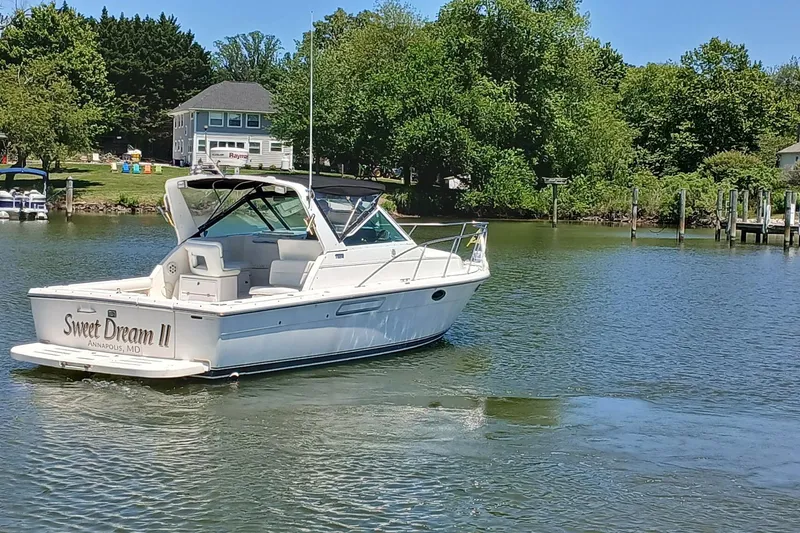 Slide: The Image of 2001 Tiara Yachts 2900 Open boat on calm water near lush shoreline. - 1