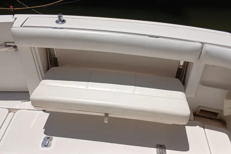 Slide: The Image of 2001 Tiara Yachts 2900 Open cockpit with covered seats and helm, docked at marina. - 11