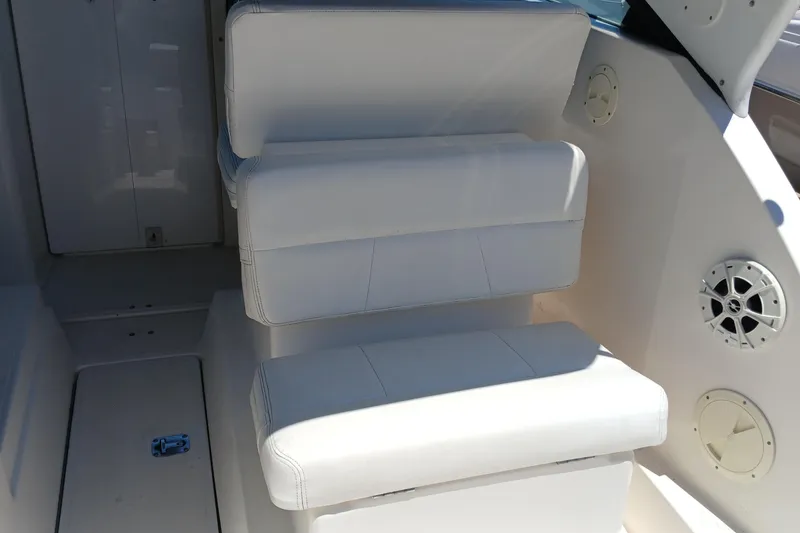 Slide: The Image of 2001 Tiara Yachts 2900 Open interior with white seating and storage compartment. - 13