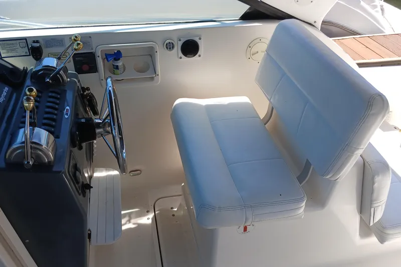 Slide: The Image of White cushioned seating on a 2001 Tiara Yachts 2900 Open boat interior. - 14