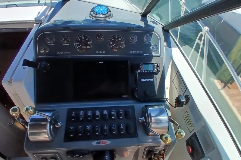 Slide: The Image of 2001 Tiara Yachts 2900 Open helm with steering wheel and controls. - 15
