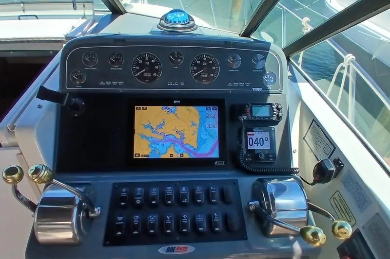 Slide: The Image of Helm of 2001 Tiara Yachts 2900 Open with navigation instruments and controls. - 16