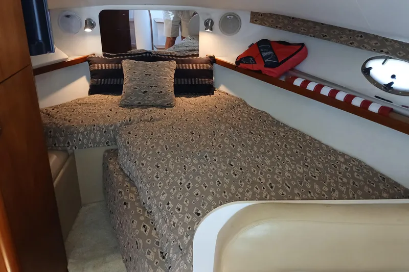 Slide: The Image of Interior of 2001 Tiara Yachts 2900 Open, featuring cozy cabin and seating area. - 18