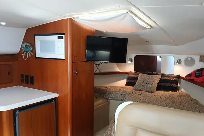 Slide: The Image of 2001 Tiara Yachts 2900 Open cabin interior with patterned bedding and nautical decor. - 19
