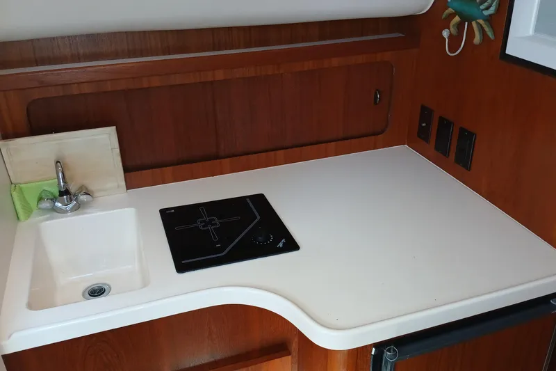 Slide: The Image of 2001 Tiara Yachts 2900 Open interior with bed, TV, microwave, and seating area. - 20