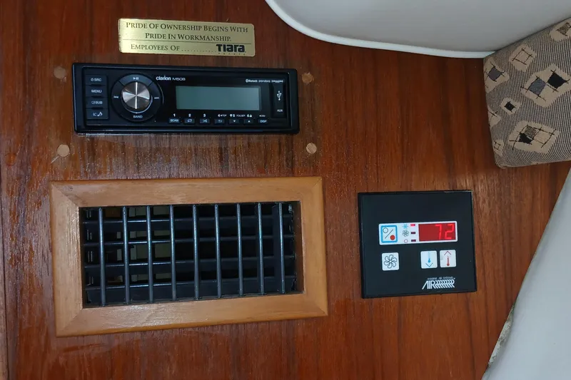 Slide: The Image of Interior of 2001 Tiara Yachts 2900 Open with stereo and climate control panel. - 23