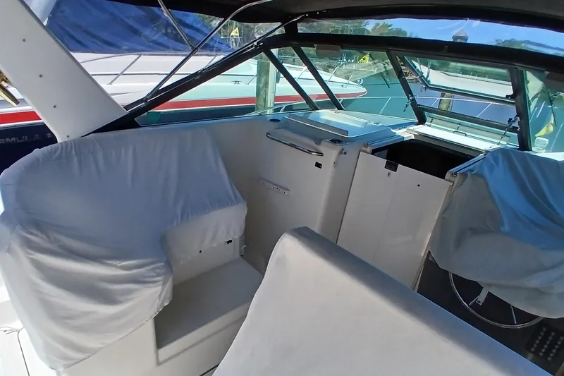 Slide: The Image of 2001 Tiara Yachts 2900 Open boat docked, featuring covered seats and a spacious cockpit. - 9