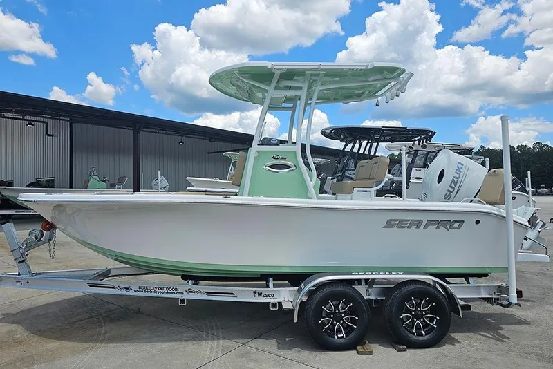 The Image of 2026 Sea Pro 202 Center Console boat on trailer under blue sky. - 1