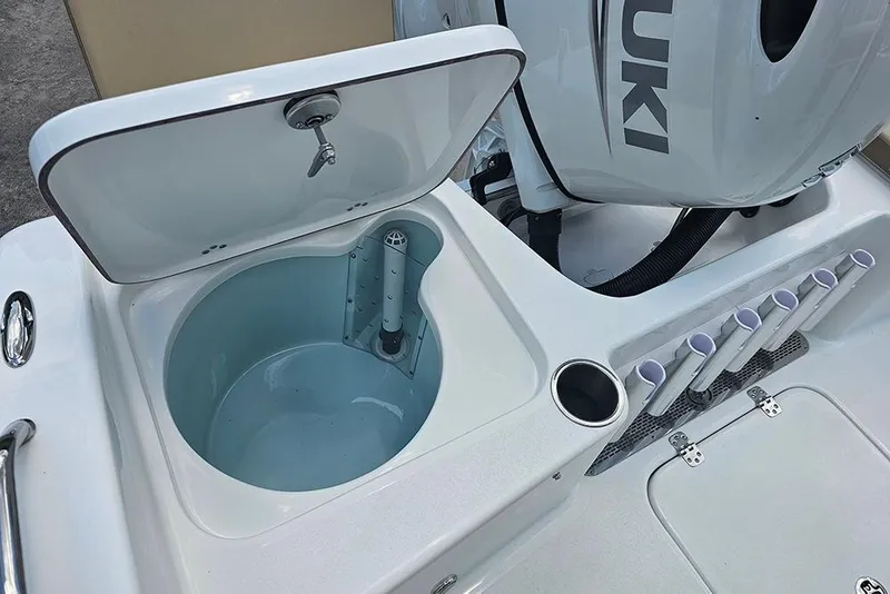 Slide: The Image of 2026 Sea Pro 202 Center Console boat with open storage compartment and Suzuki engine. - 10