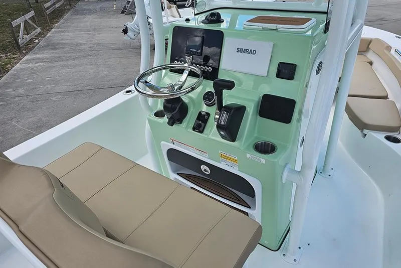 Slide: The Image of 2026 Sea Pro 202 Center Console boat interior with steering wheel and control panel. - 11