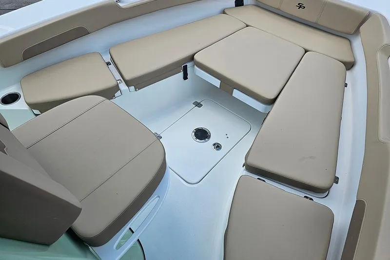 Slide: The Image of 2026 Sea Pro 202 Center Console boat interior with beige cushioned seating. - 16