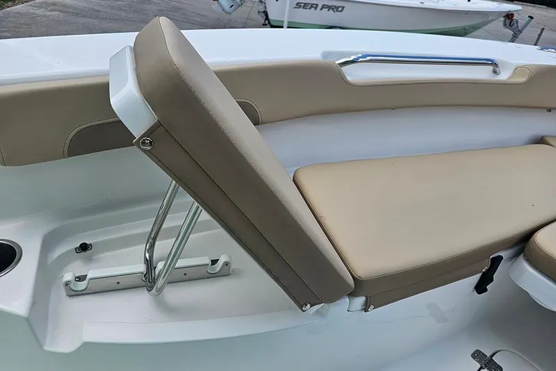 Slide: The Image of 2026 Sea Pro 202 Center Console boat seating with beige cushions and stainless steel hardware. - 18