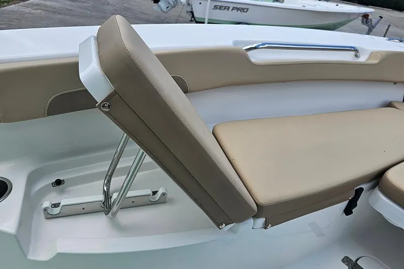 Slide: The Image of 2026 Sea Pro 202 Center Console boat with beige seating and stainless steel fixtures. - 19