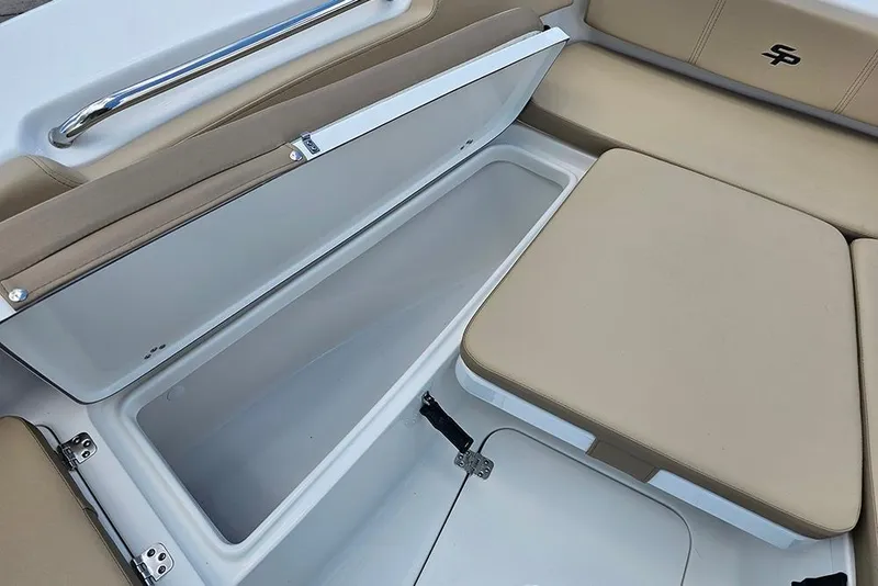 Slide: The Image of 2026 Sea Pro 202 Center Console boat with open storage compartment and beige seating. - 20