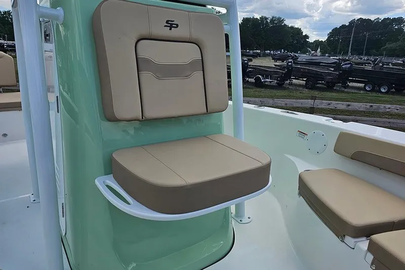 Slide: The Image of 2026 Sea Pro 202 Center Console boat with beige seating and green accents. - 21