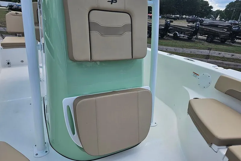 Slide: The Image of 2026 Sea Pro 202 Center Console boat interior with beige seating and mint green accents. - 22