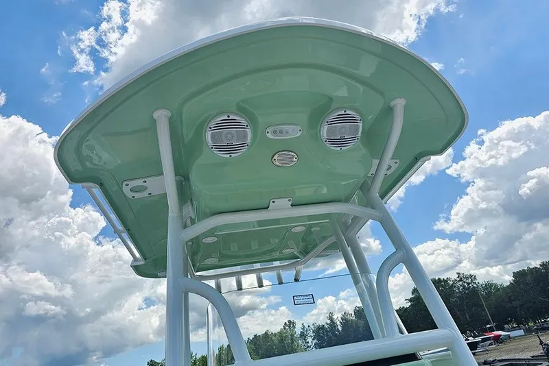 Slide: The Image of 2026 Sea Pro 202 Center Console boat with green T-top under a blue sky. - 23