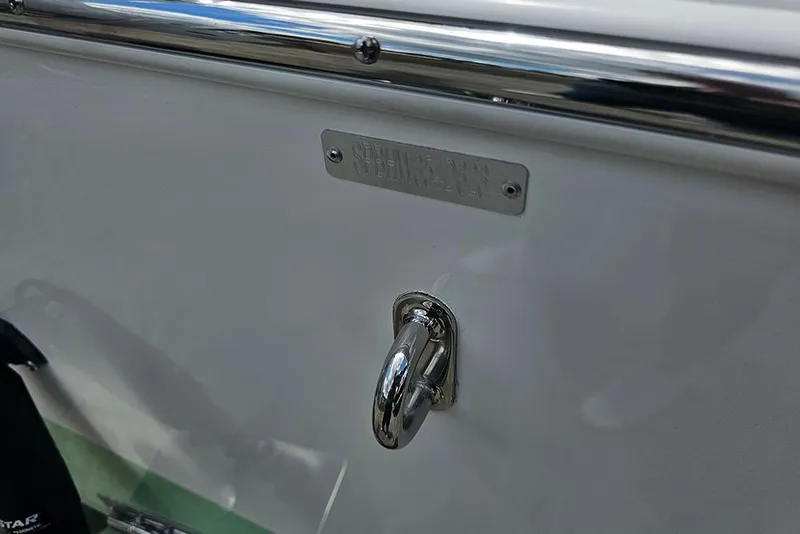 Slide: The Image of Close-up of a 2026 Sea Pro 202 Center Console boat's metal hook and nameplate. - 25